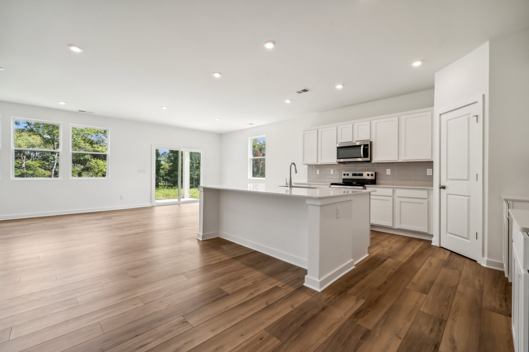 A kitchen with white cabinets.