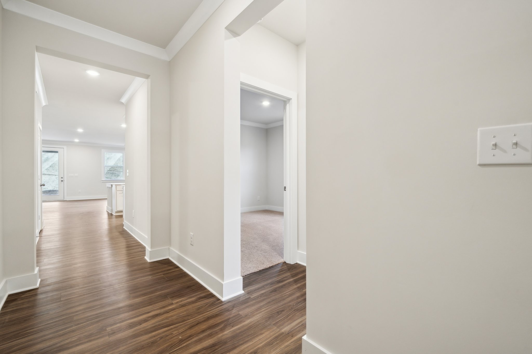 A hallway with white walls.