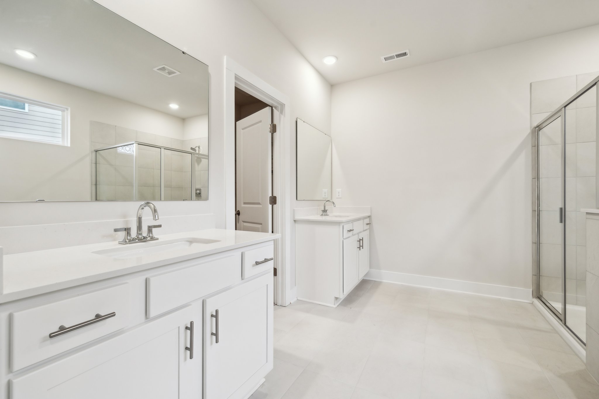 A bathroom with white cabinets.