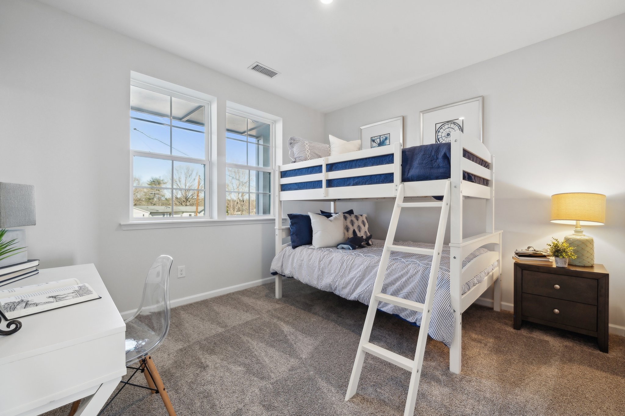 A room with a bed and a desk.