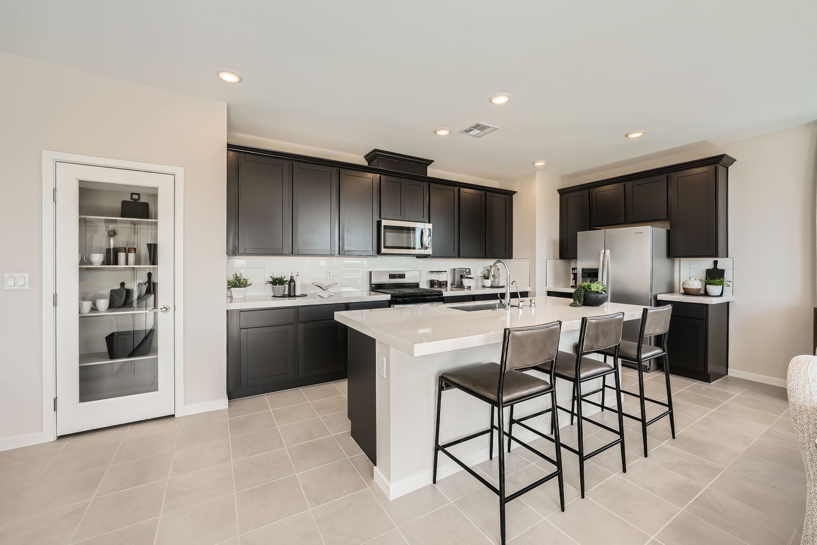 A kitchen with black cabinets.
