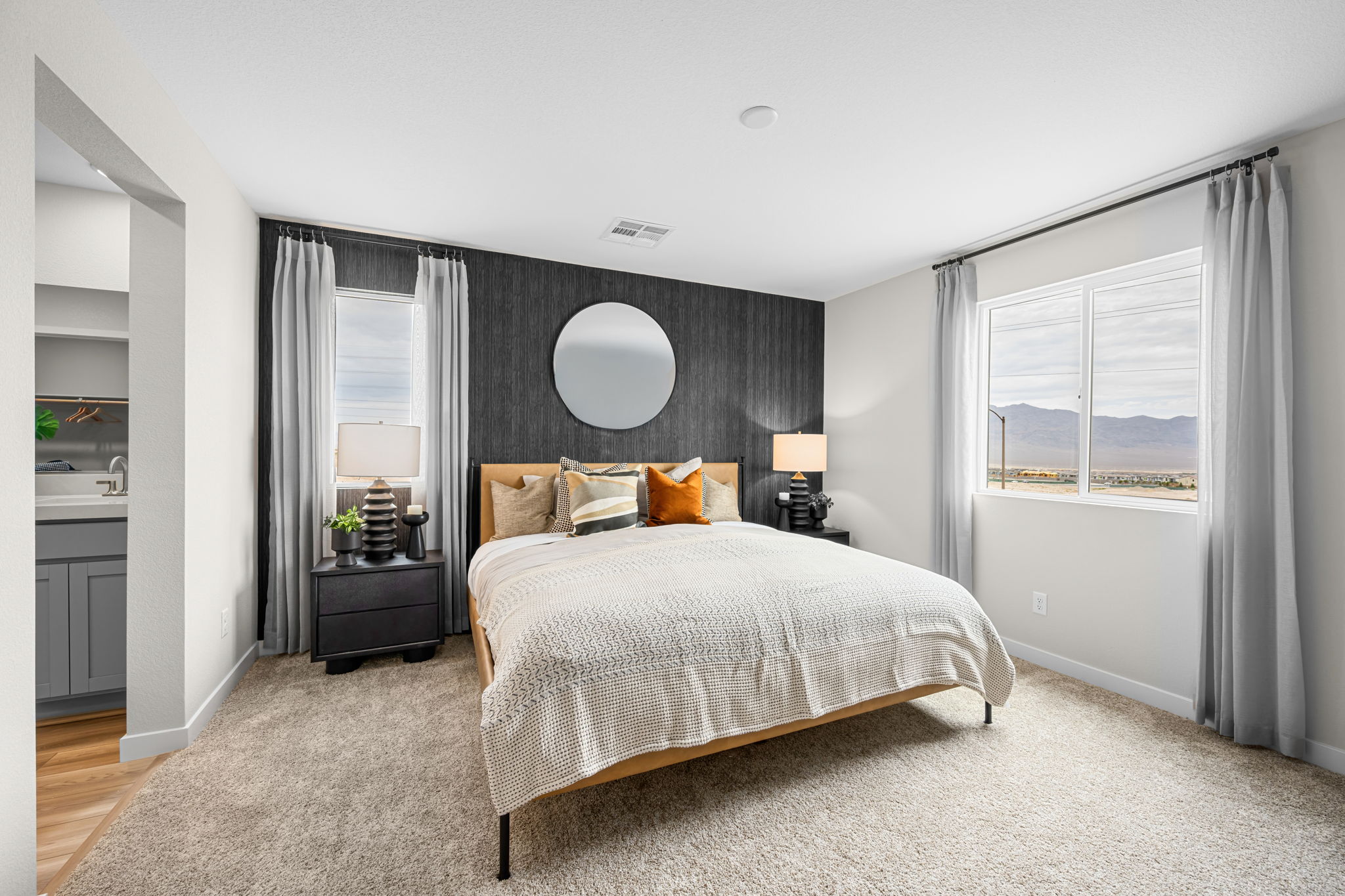 A bedroom with a bed and a lamp.