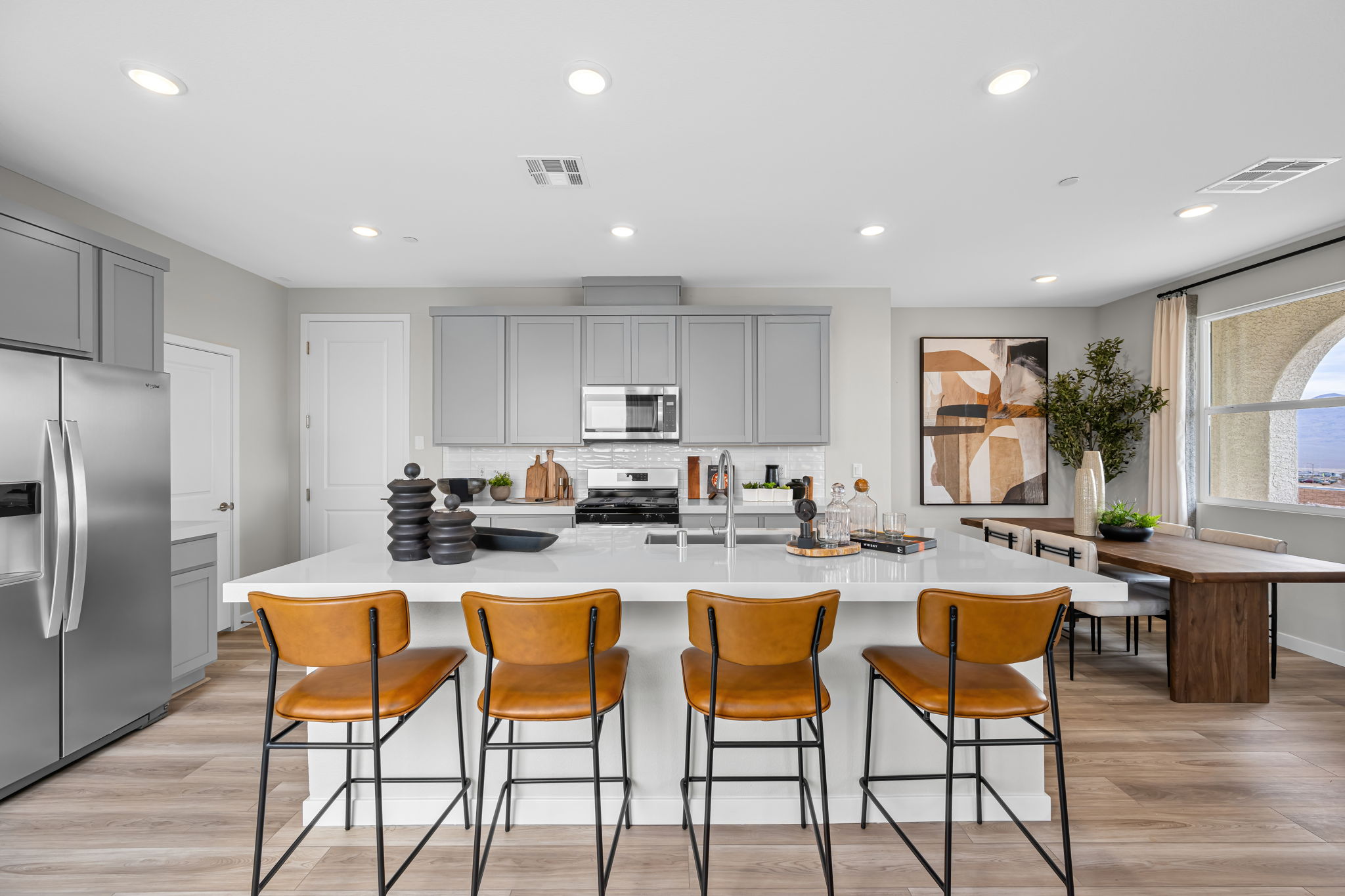 A kitchen with a table and chairs.