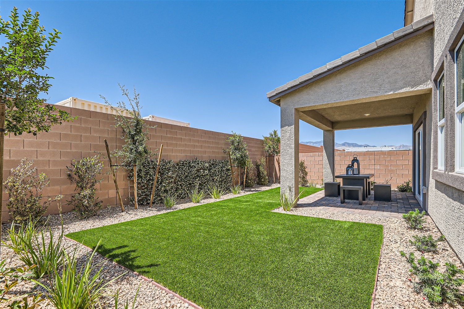 A backyard with a brick wall and a brick wall.
