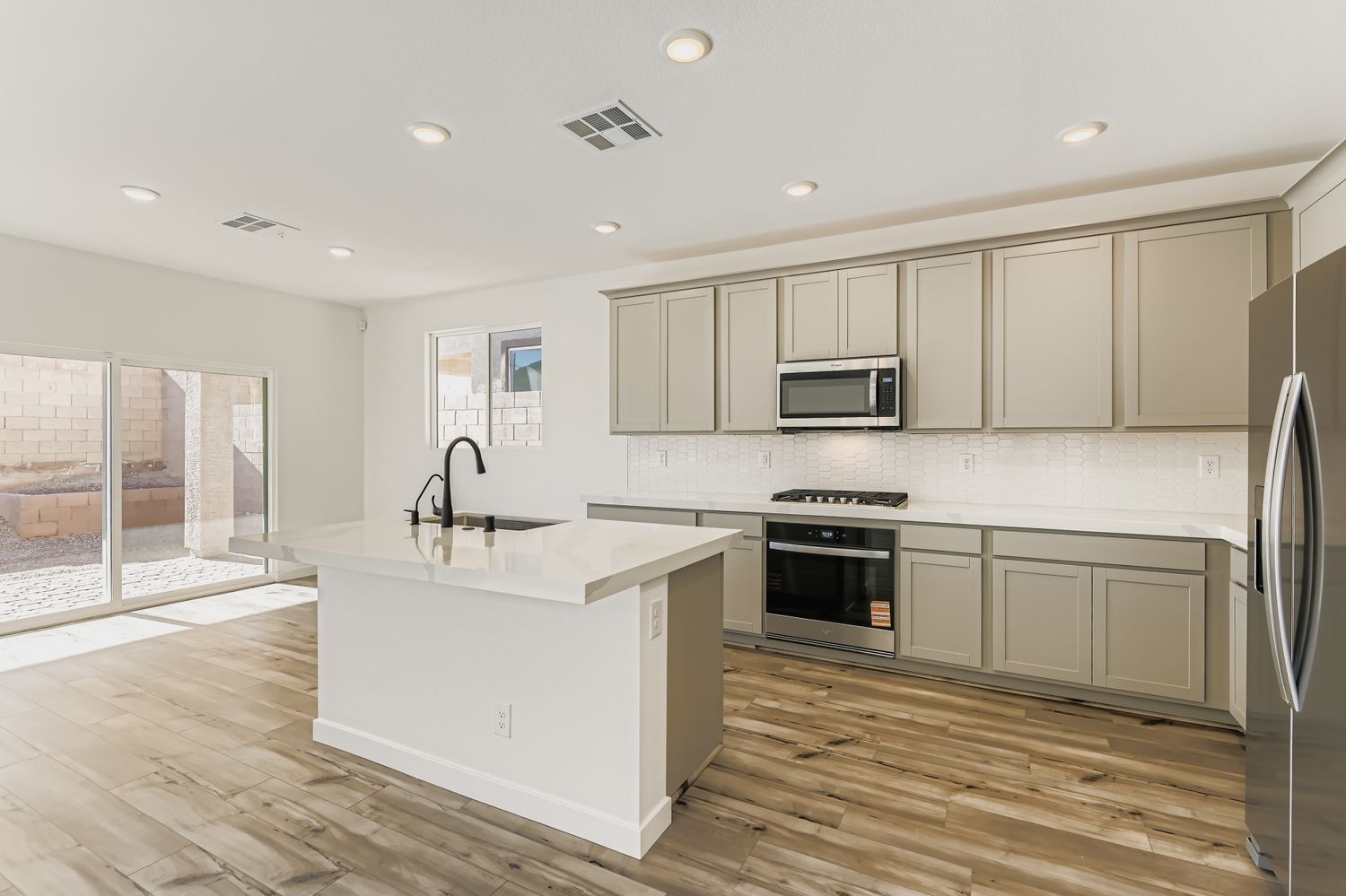 A kitchen with white cabinets.