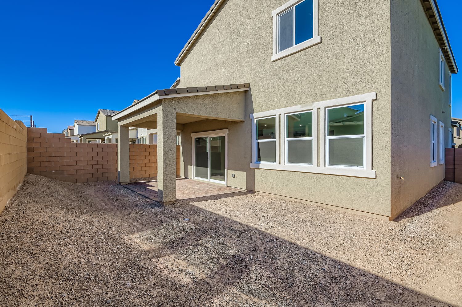 A house with a gravel driveway.