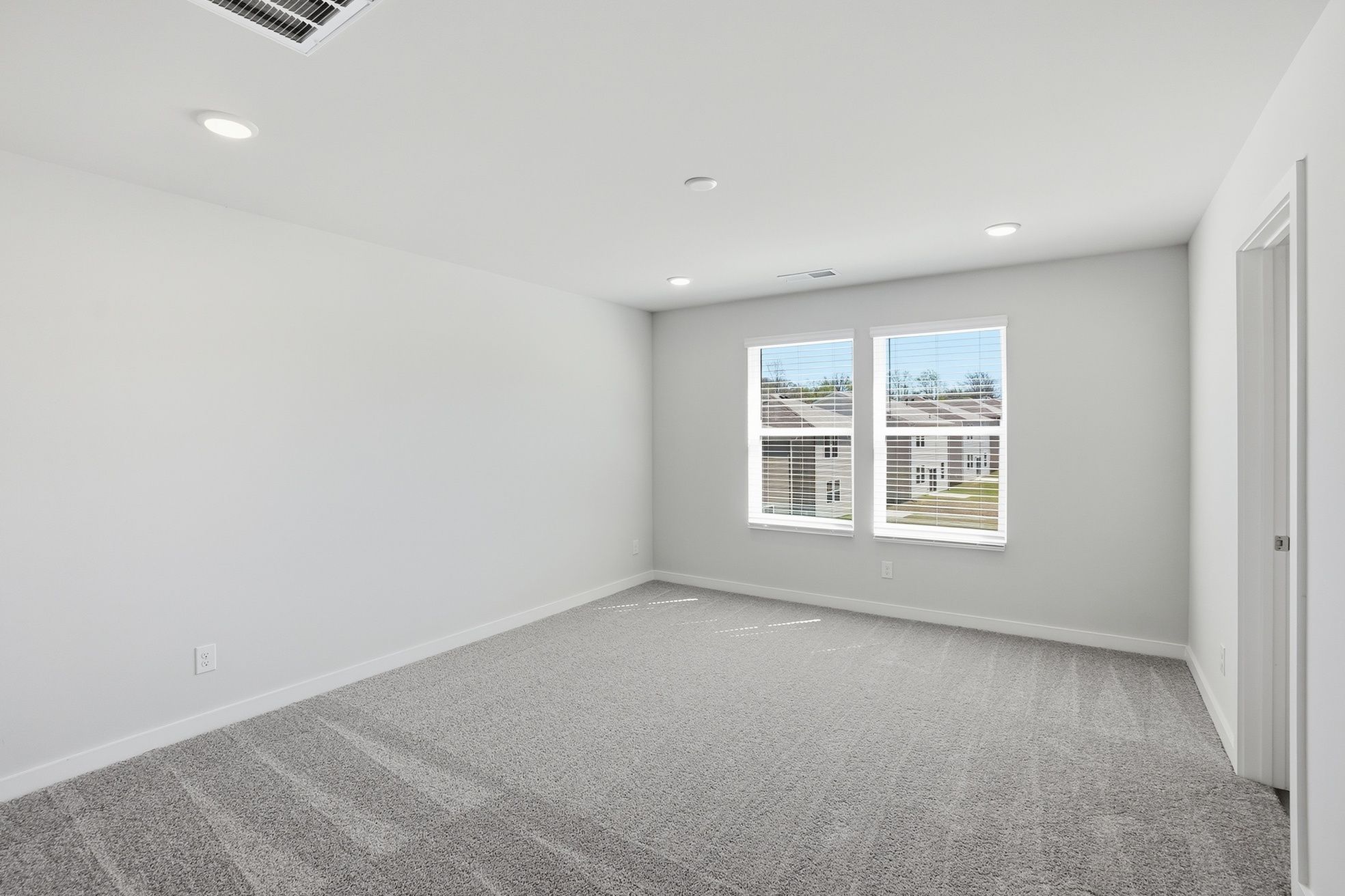 A room with a window and a carpet.