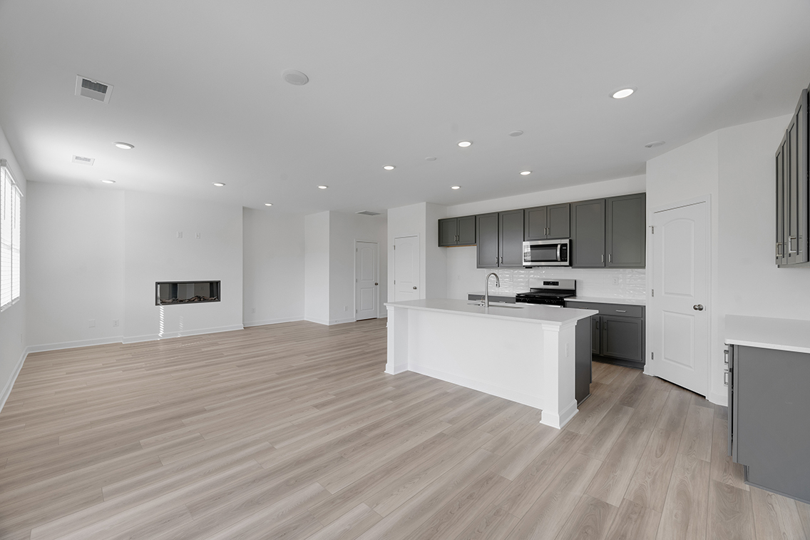 A large kitchen with white cabinets.