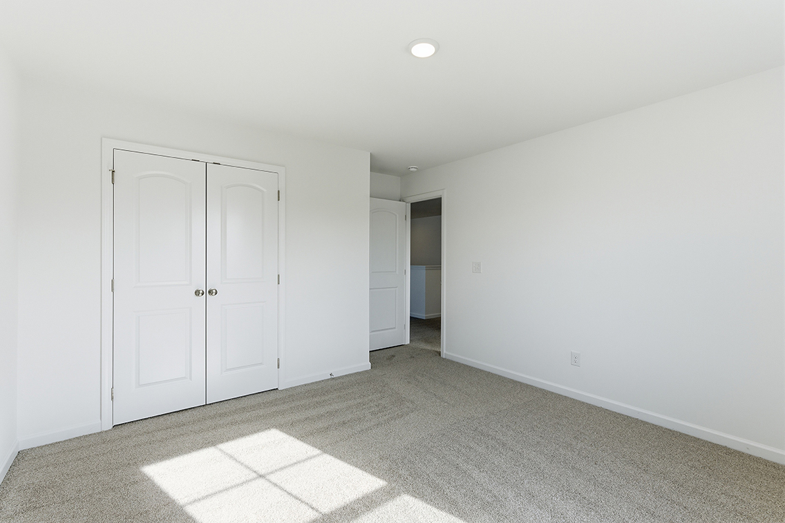A hallway with white doors.