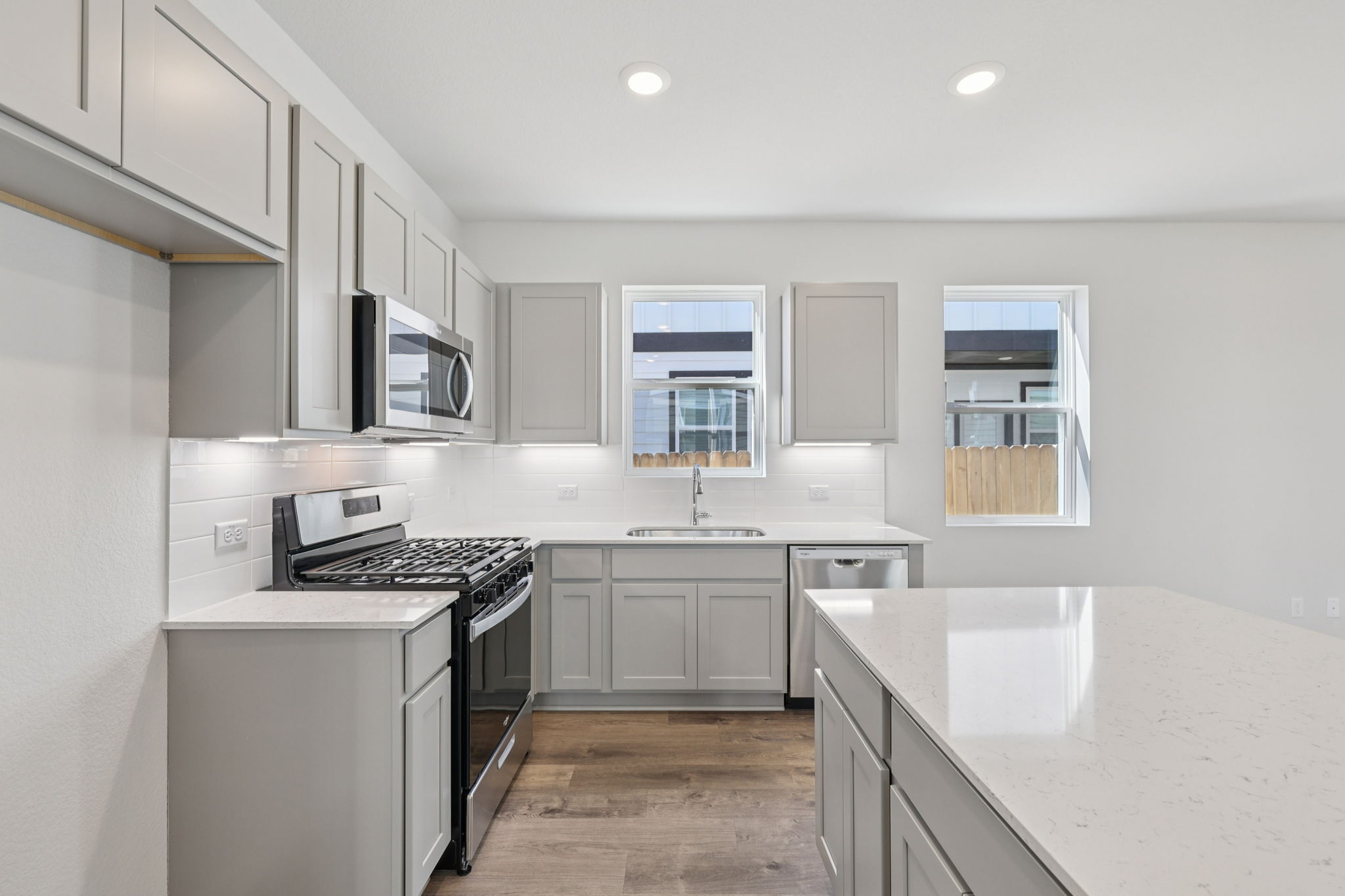 A kitchen with white cabinets.