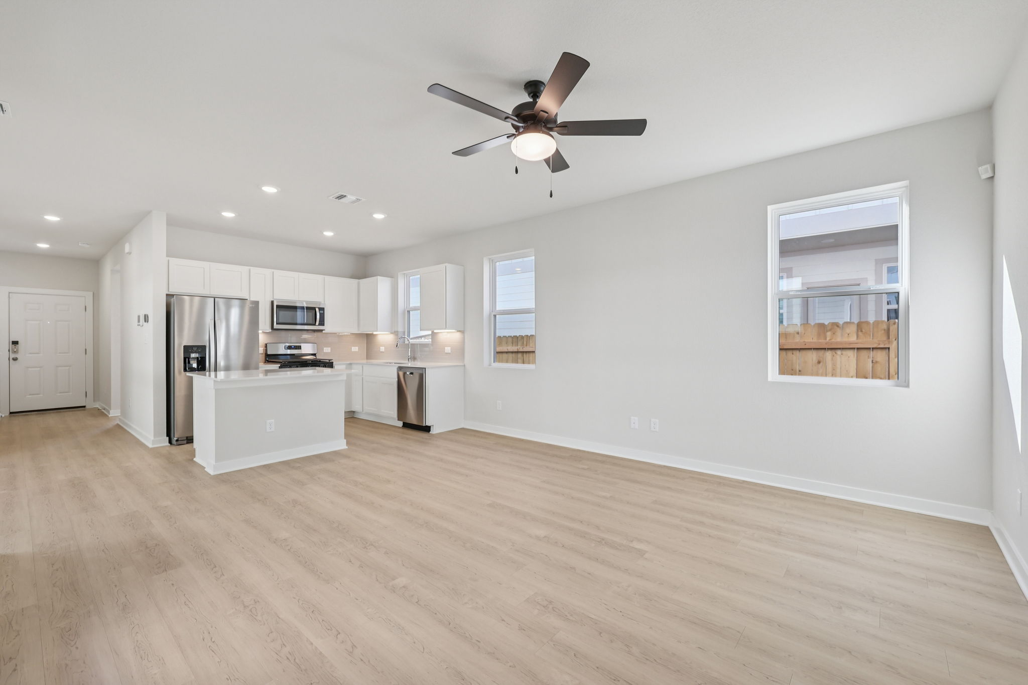 A large kitchen with white cabinets.