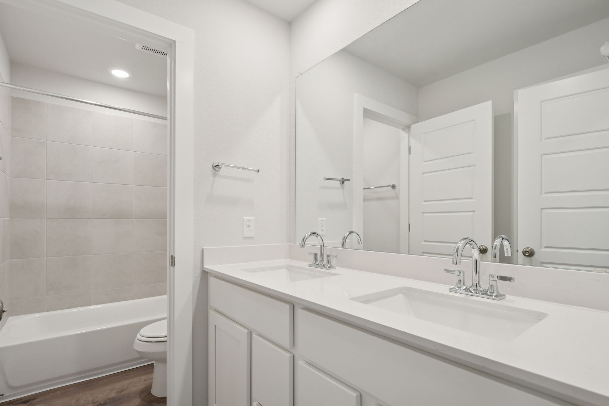 A bathroom with a tub sink and toilet.
