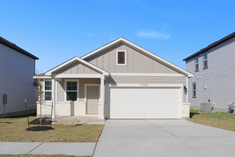 A white house with garages.