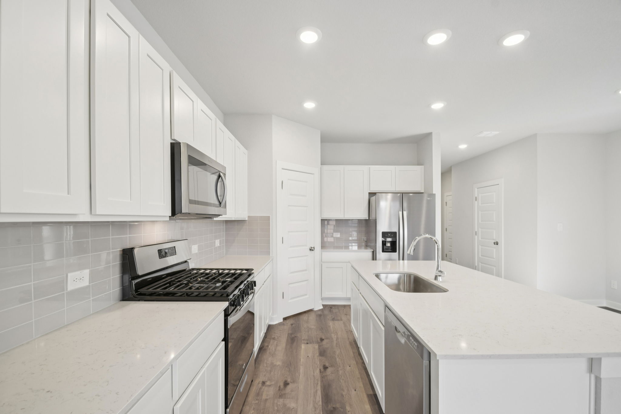 A kitchen with white cabinets.