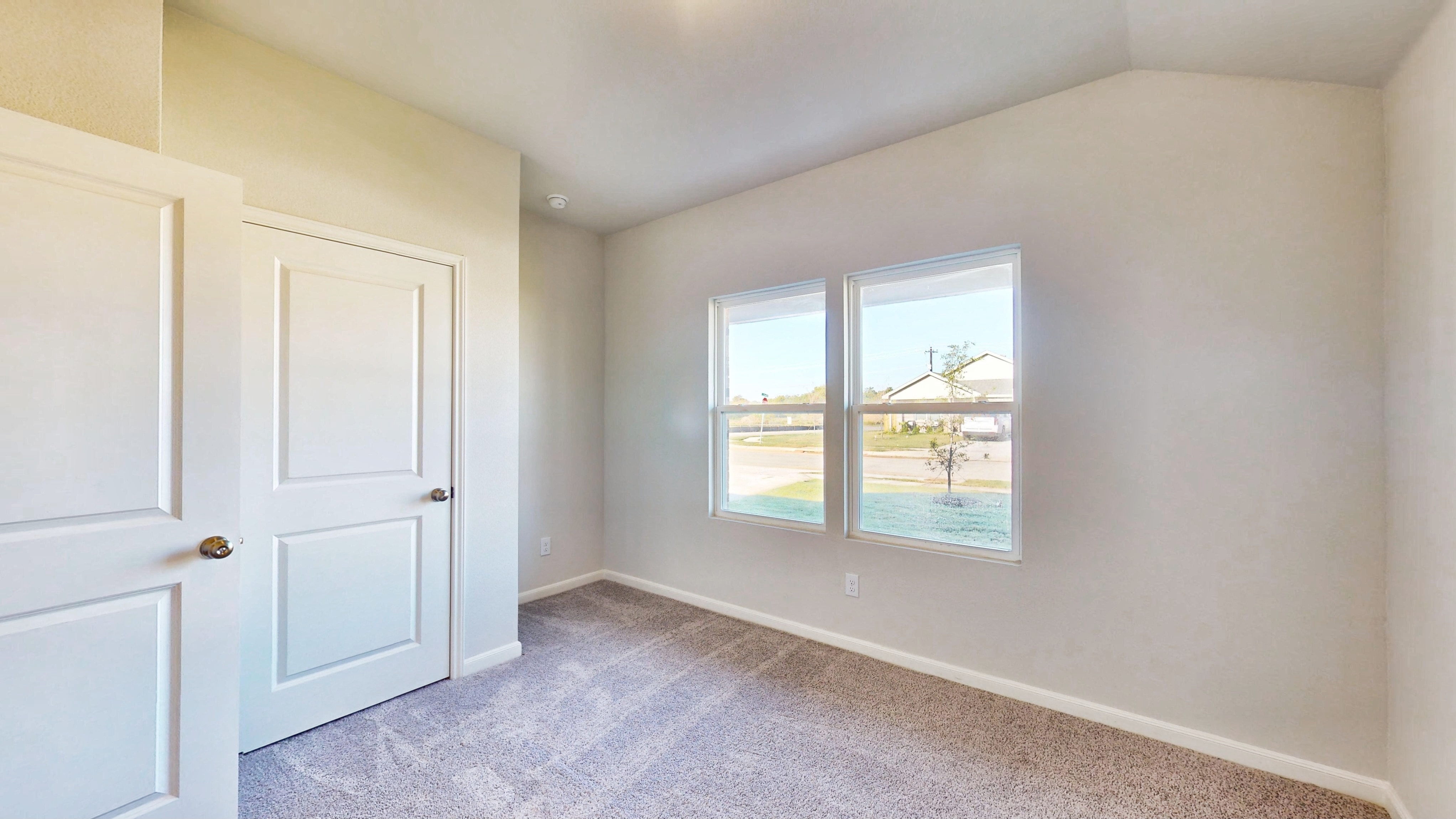 A room with white doors and a window.