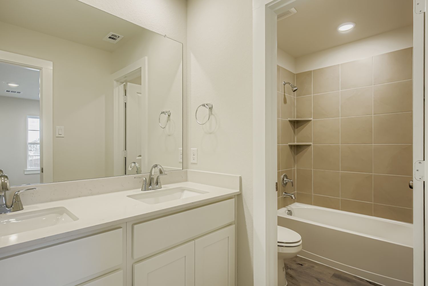 A bathroom with a tub sink and toilet.