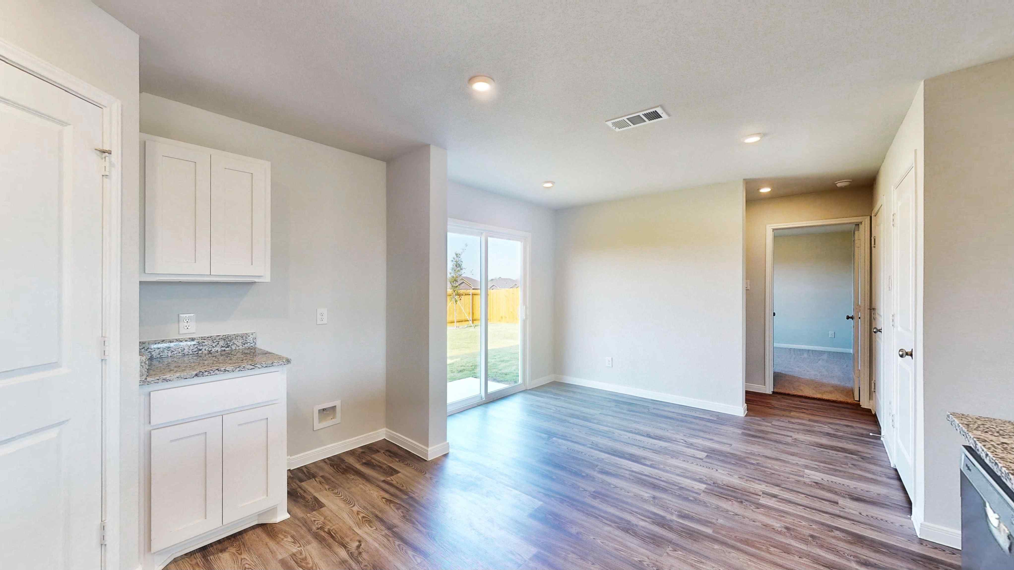 A kitchen with white cabinets.
