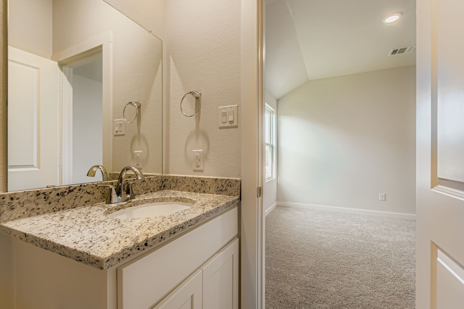 A bathroom with a marble countertop.