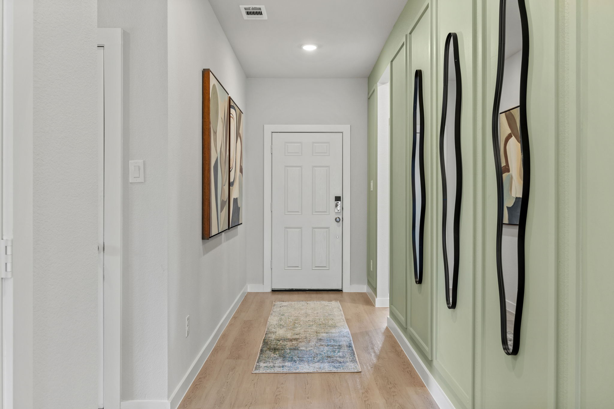 A hallway with white walls.