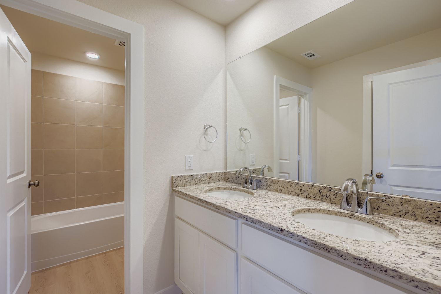 A bathroom with a marble countertop.