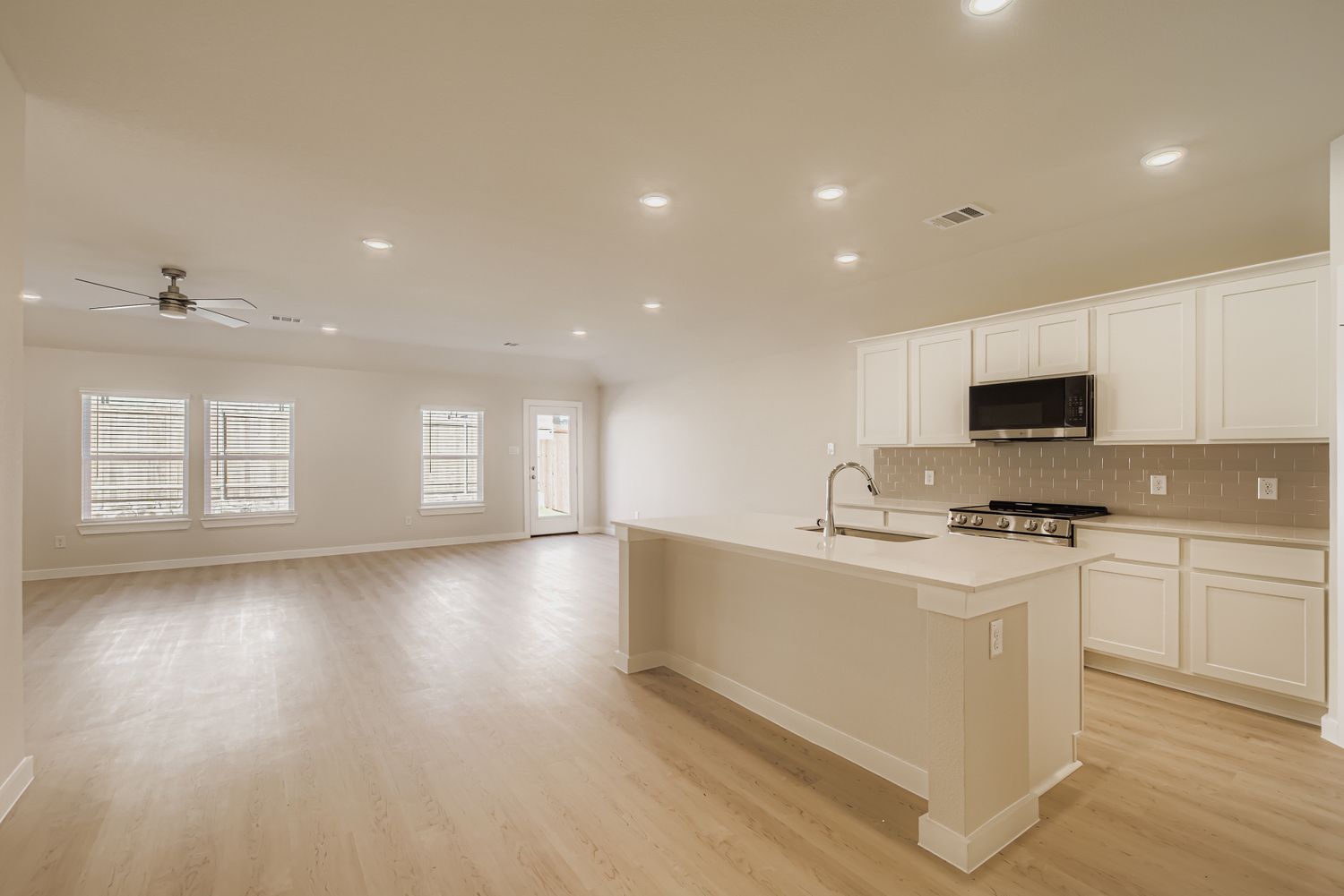 A kitchen with white cabinets.