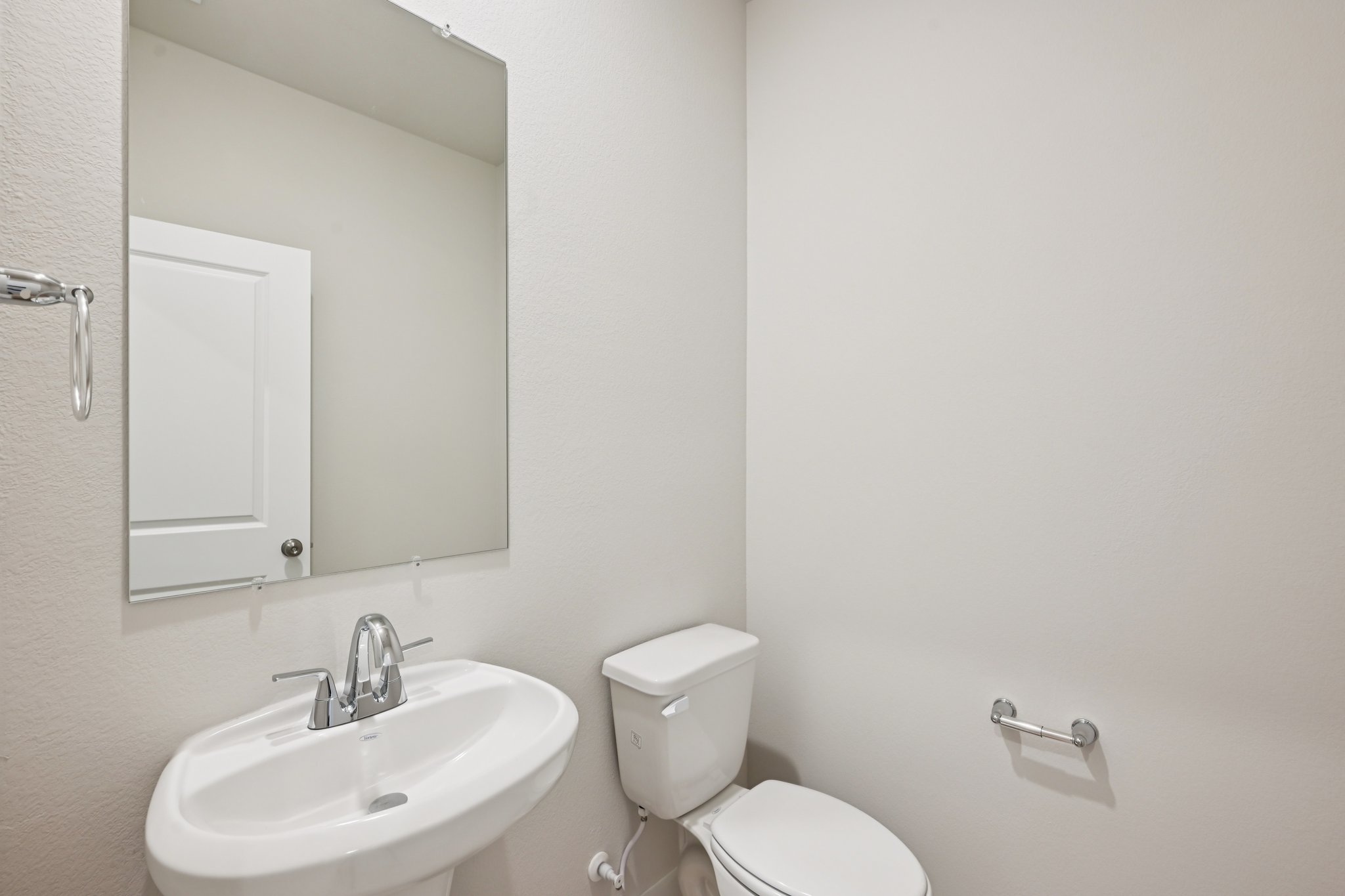 A bathroom with a toilet and sink.