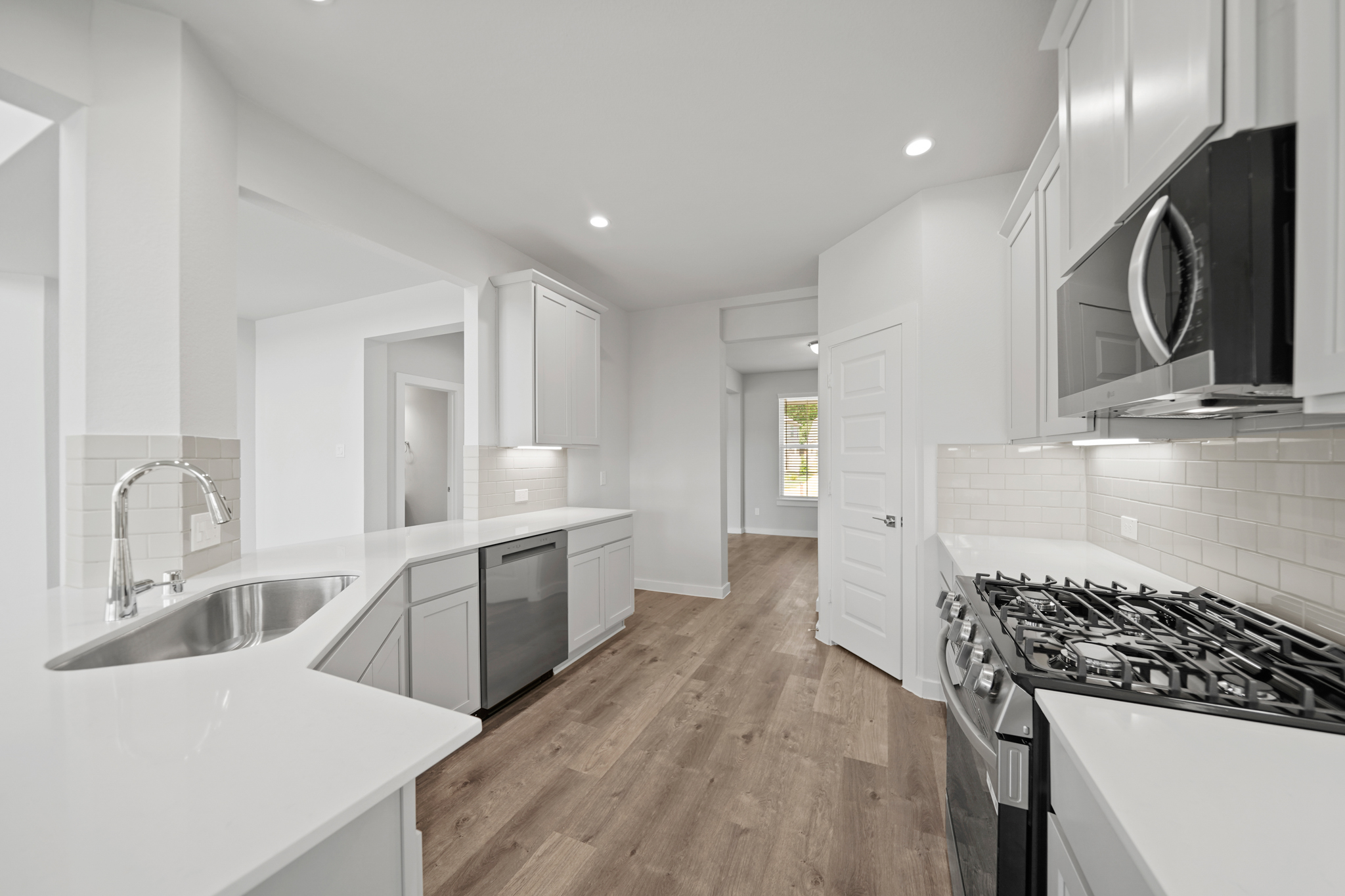A kitchen with white cabinets.