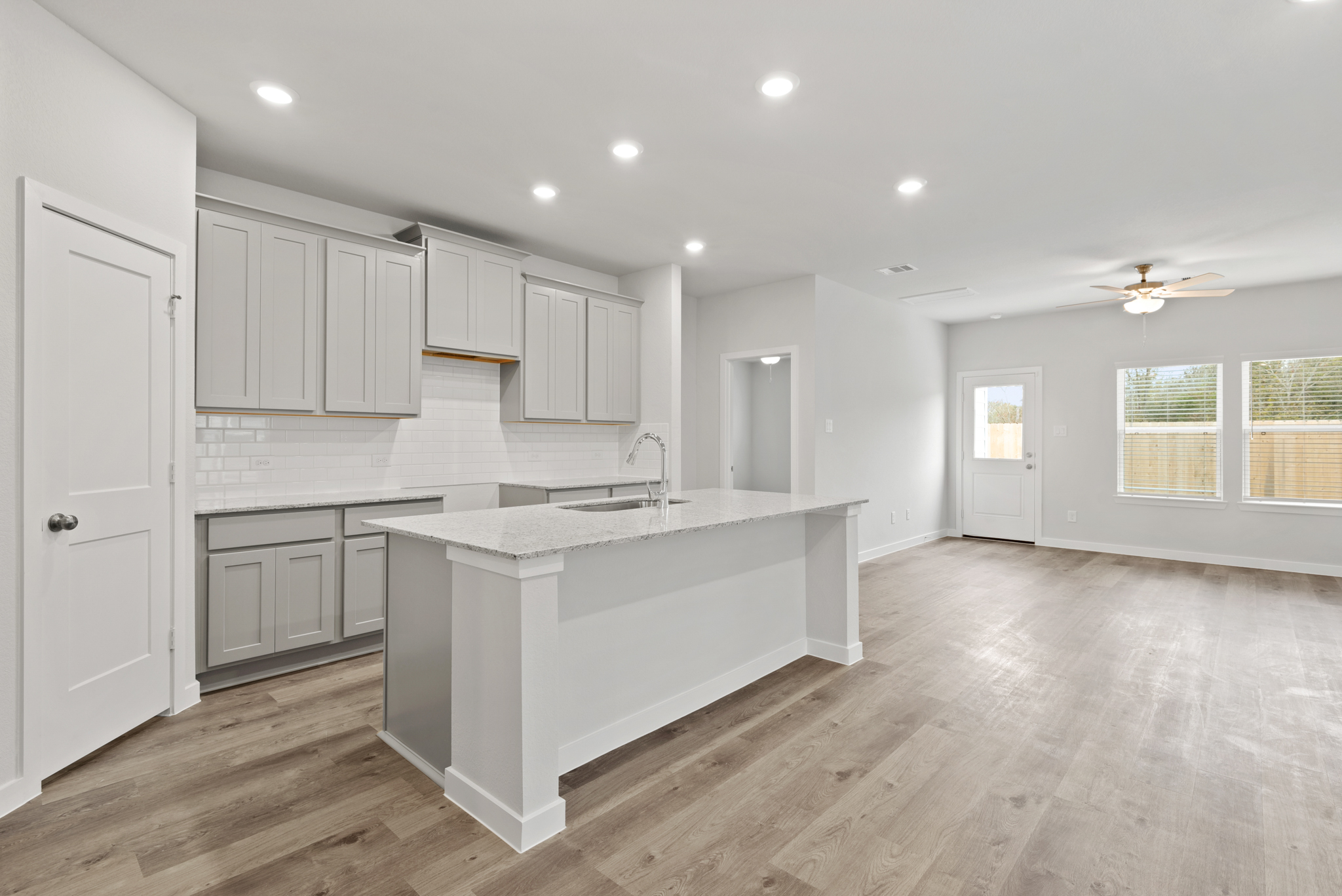 A kitchen with white cabinets.