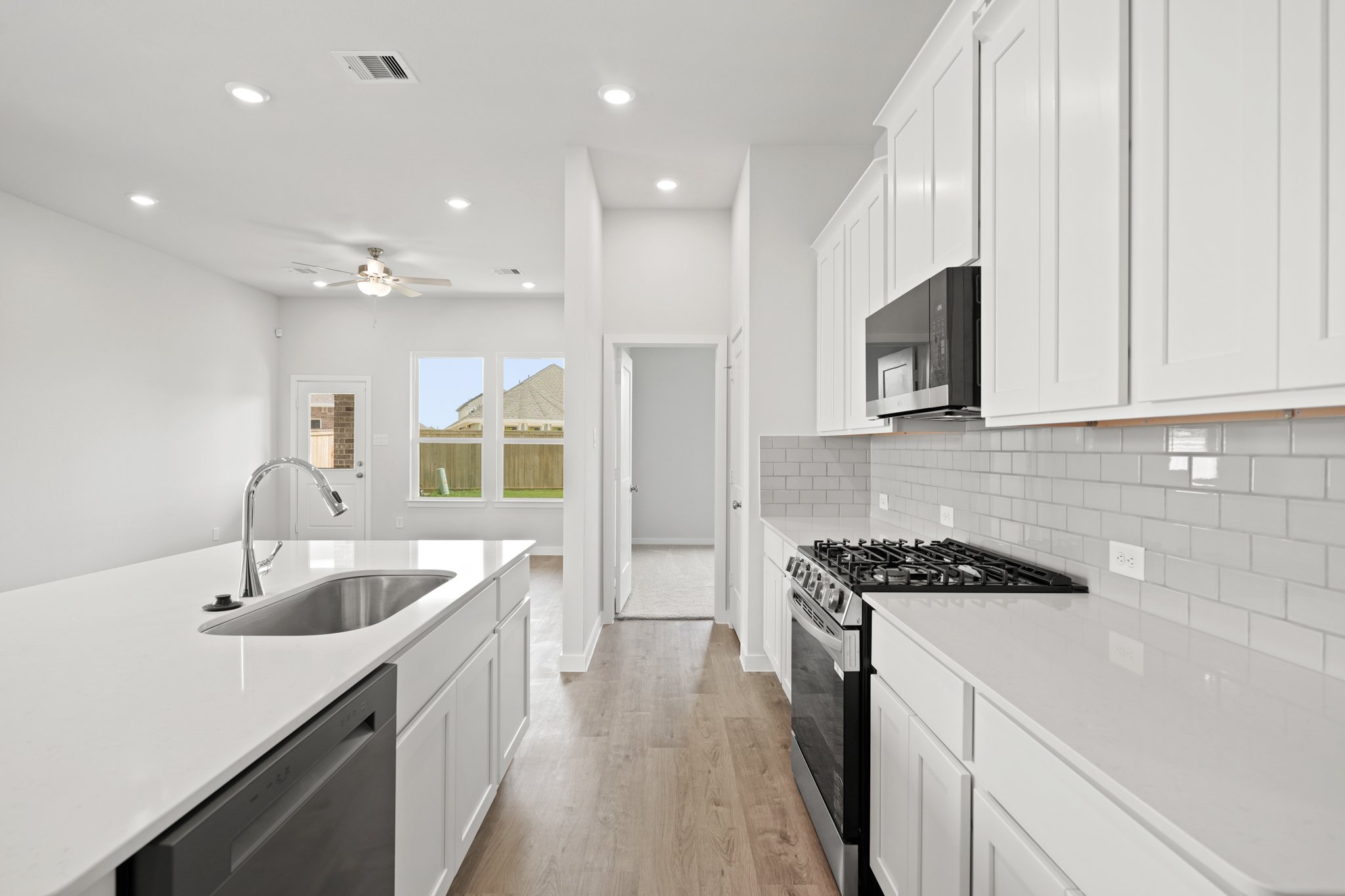 A kitchen with white cabinets.