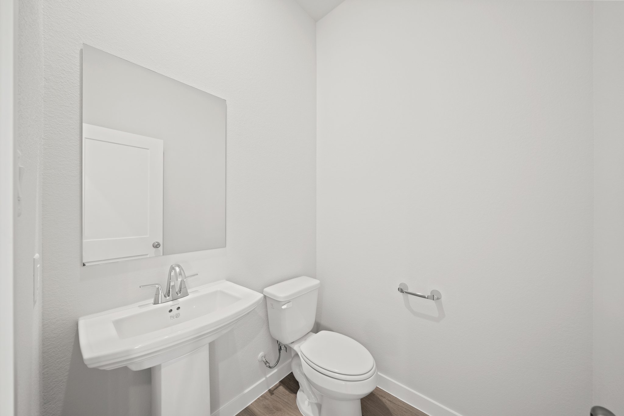 A bathroom with a toilet and sink.