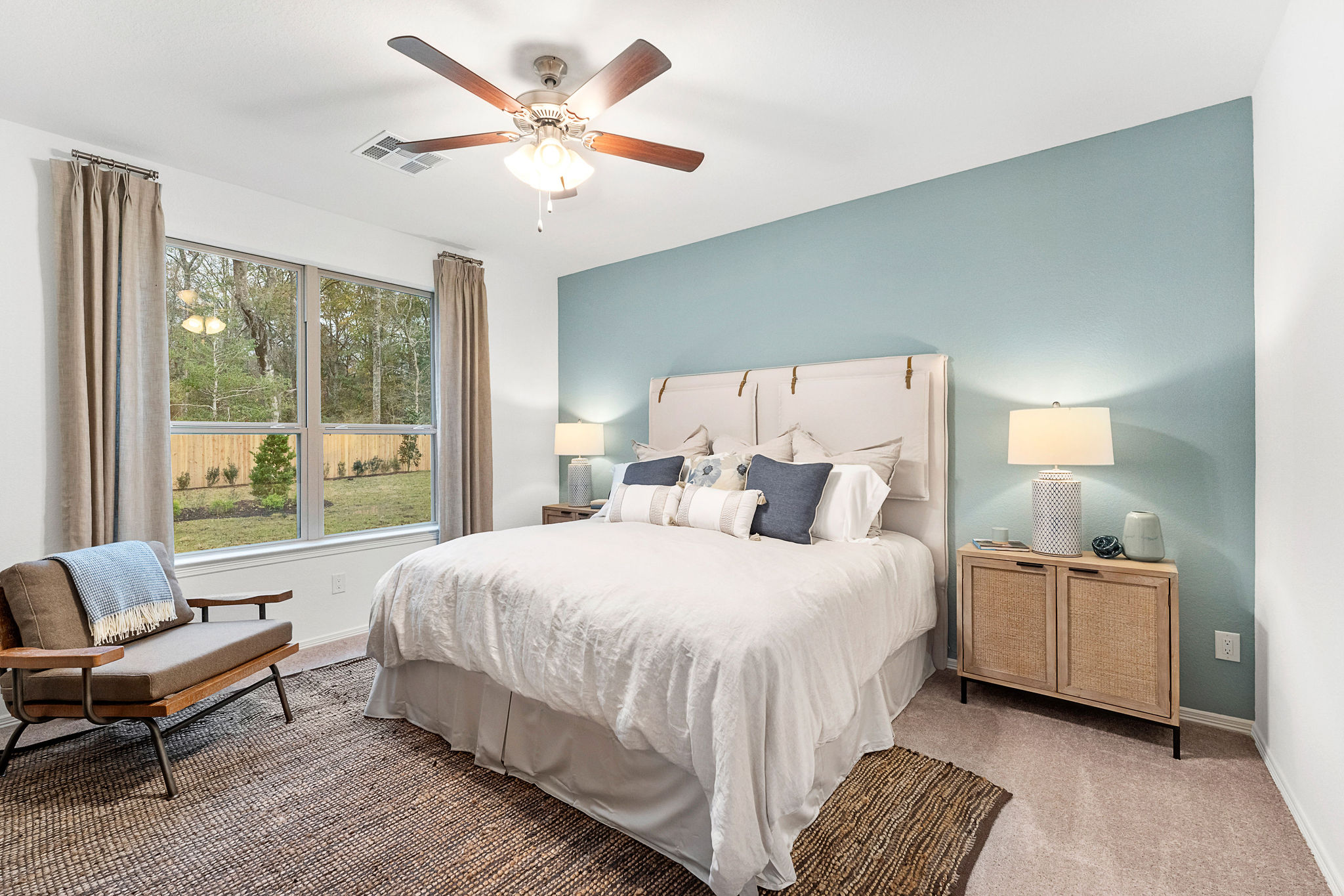 A bedroom with a bed and a fan.