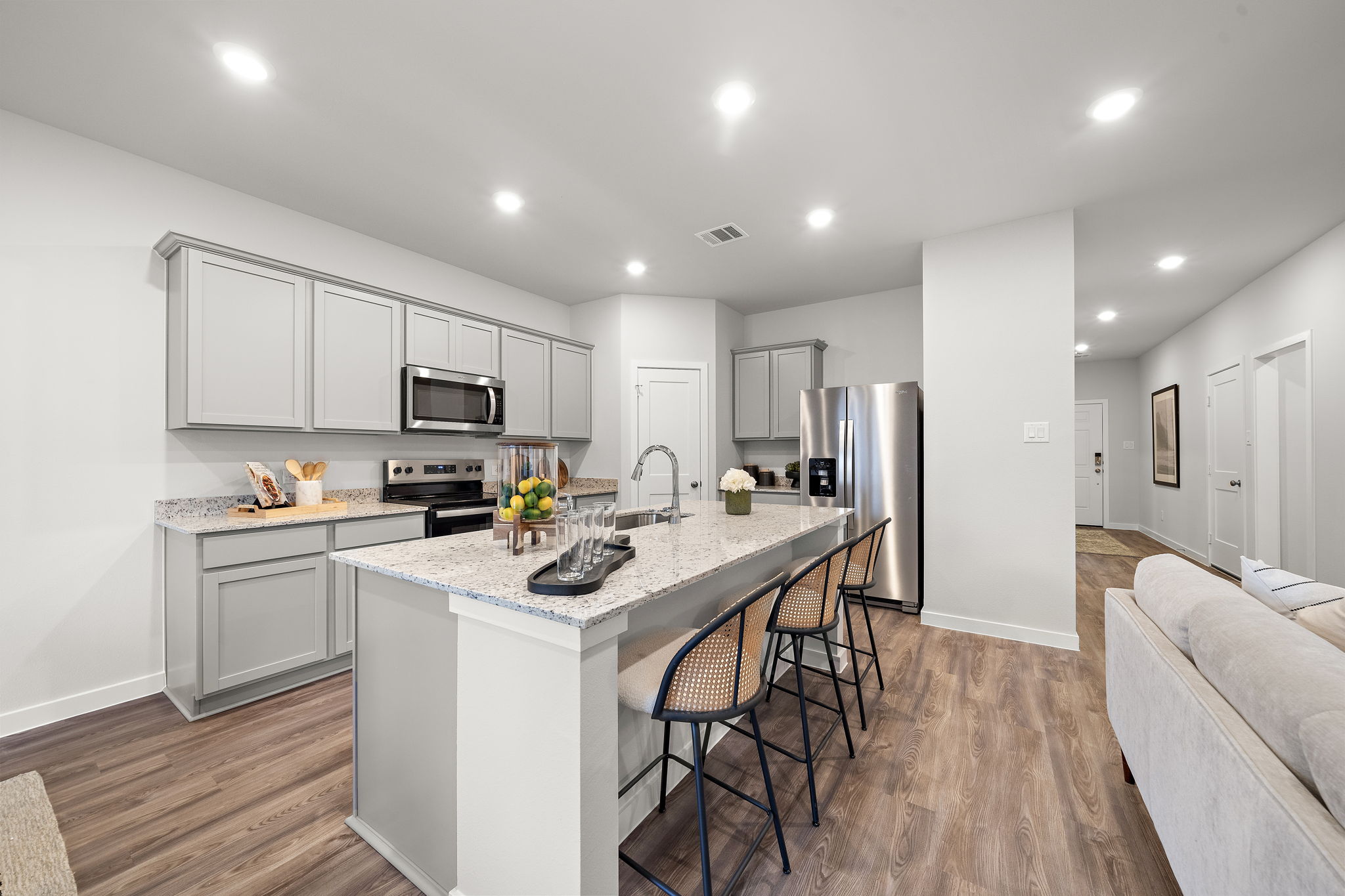 A kitchen with white cabinets.