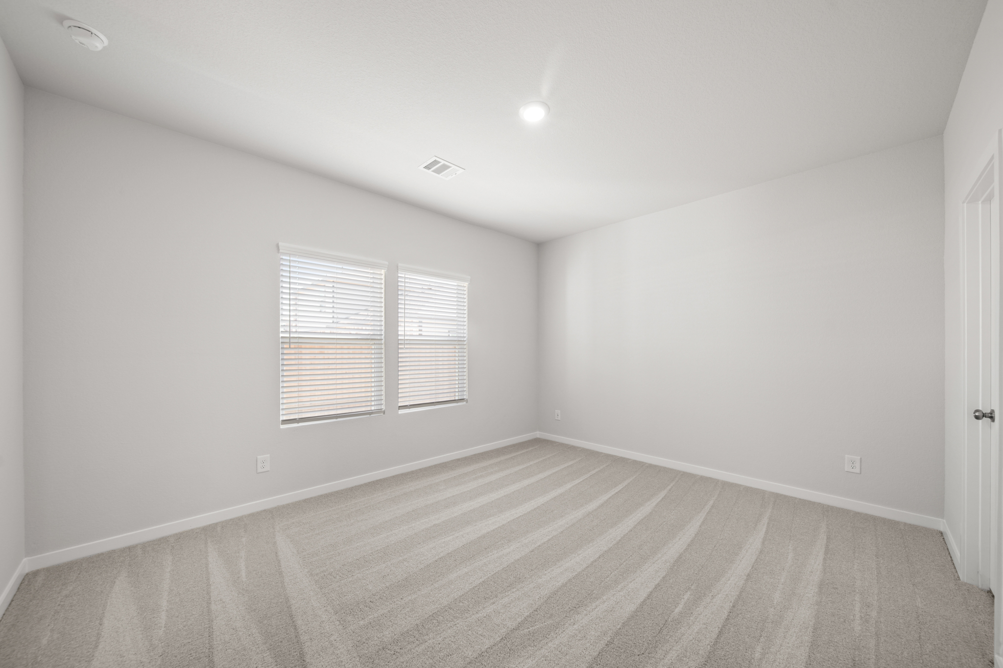 A room with a wood floor and white walls.