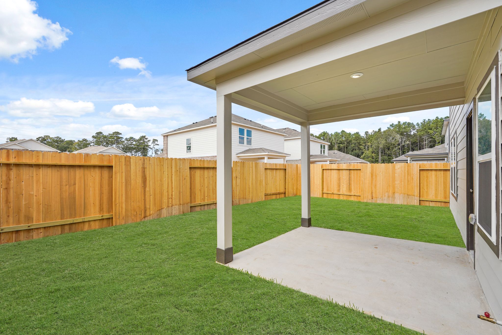 A backyard with a fence.
