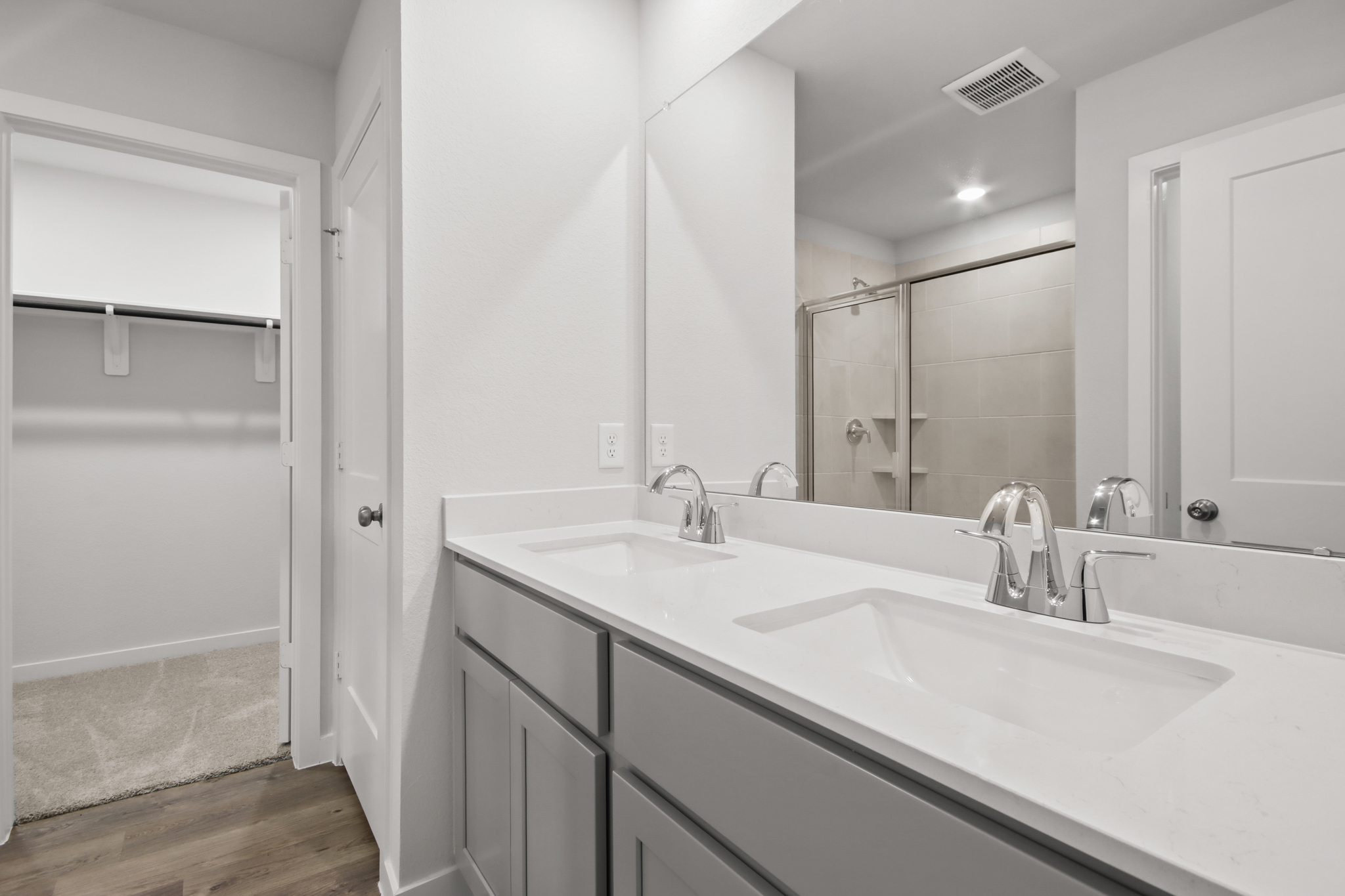 A bathroom with a large mirror.