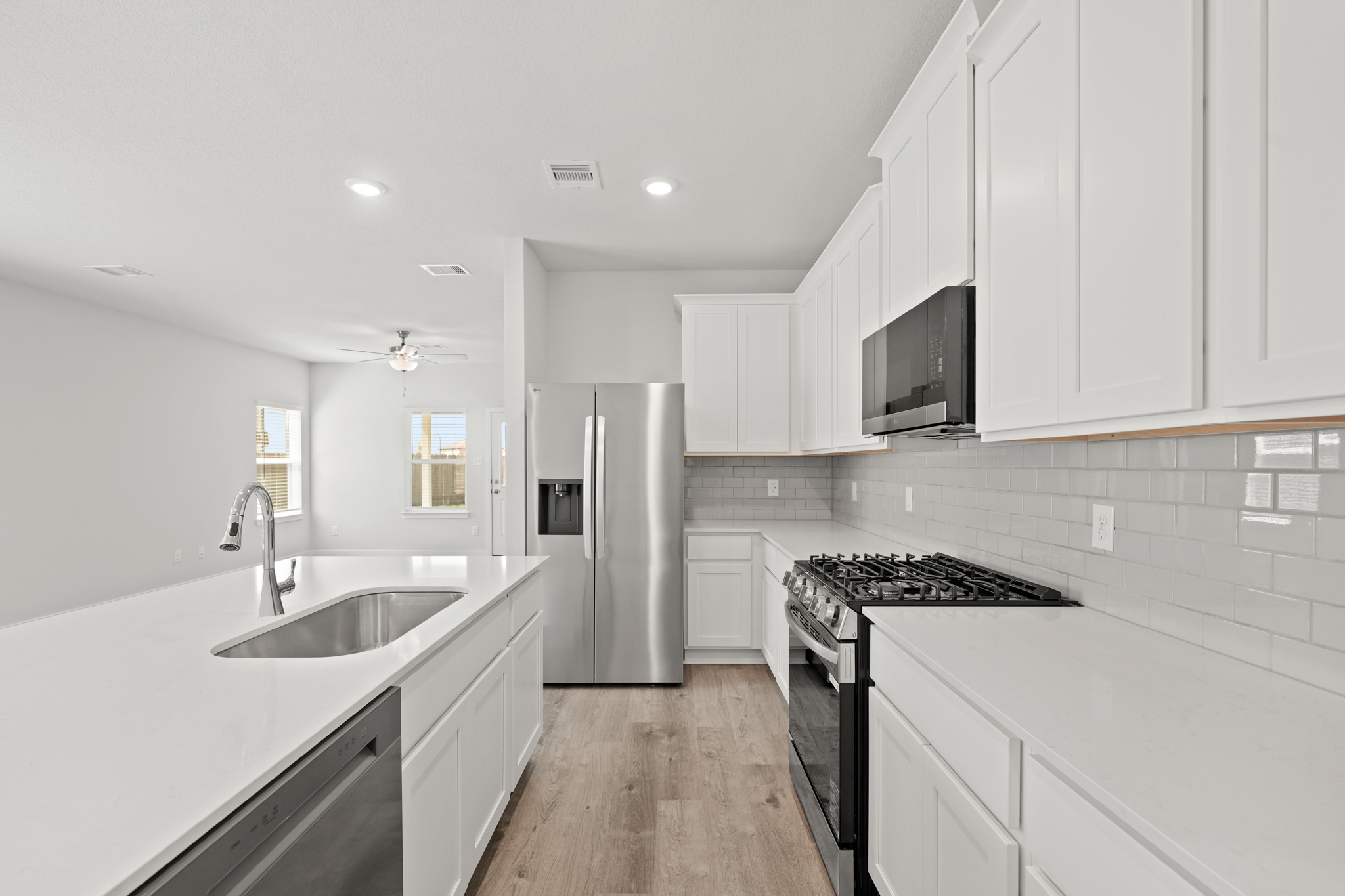 A kitchen with white cabinets.