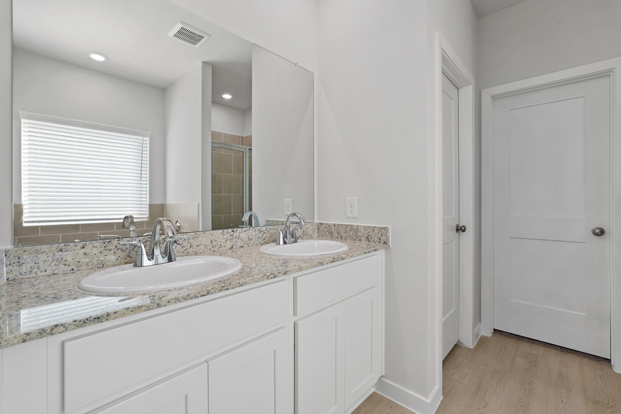 A bathroom with a marble countertop.
