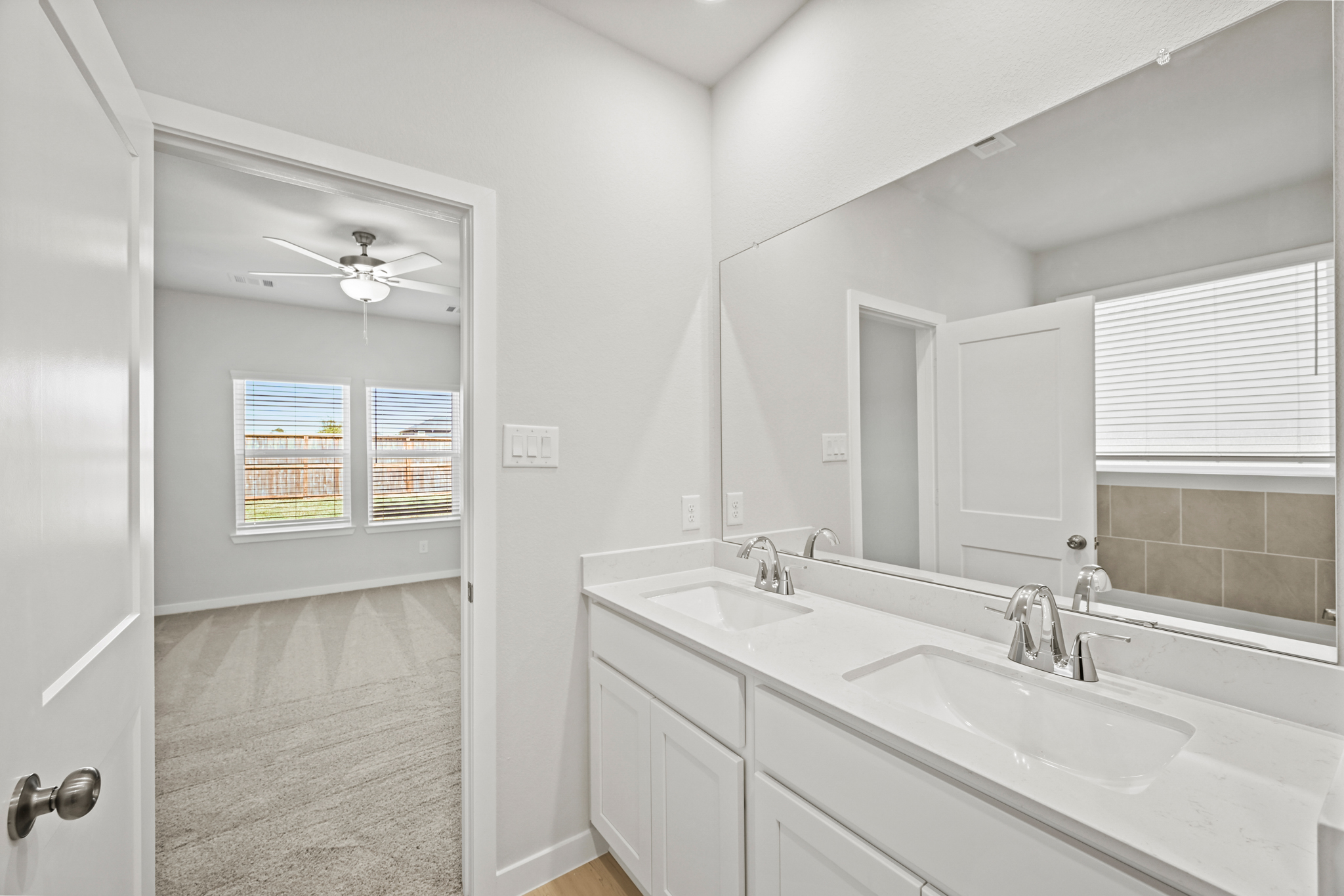 A bathroom with a large mirror.