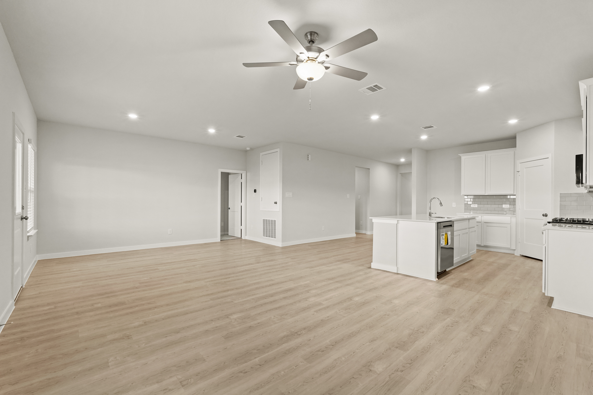 A large kitchen with white cabinets.