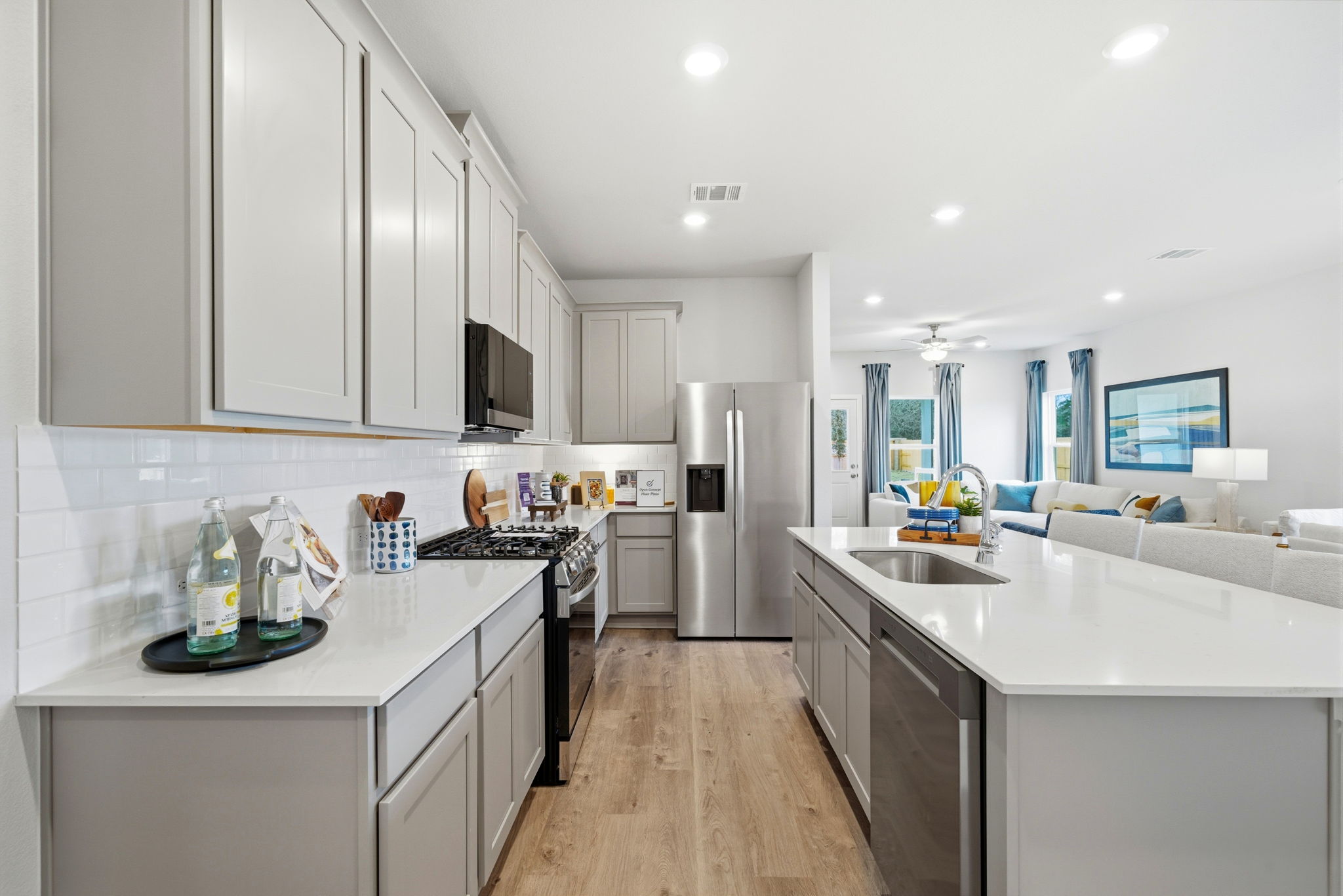 A kitchen with white cabinets.