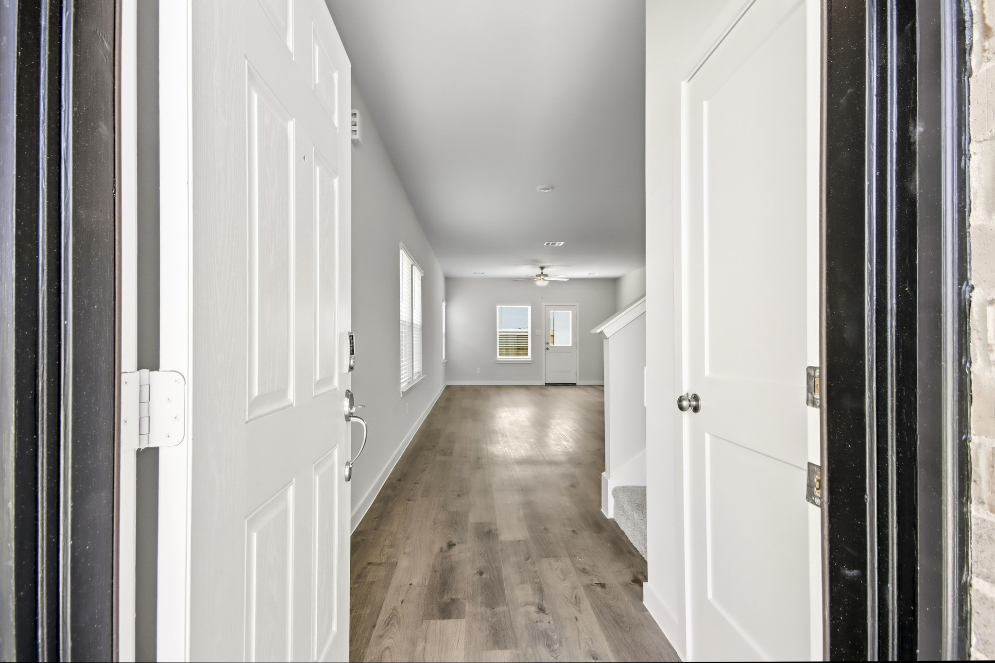 A hallway with white doors.