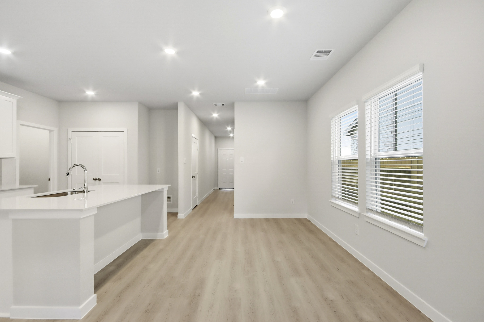 A kitchen with white cabinets.