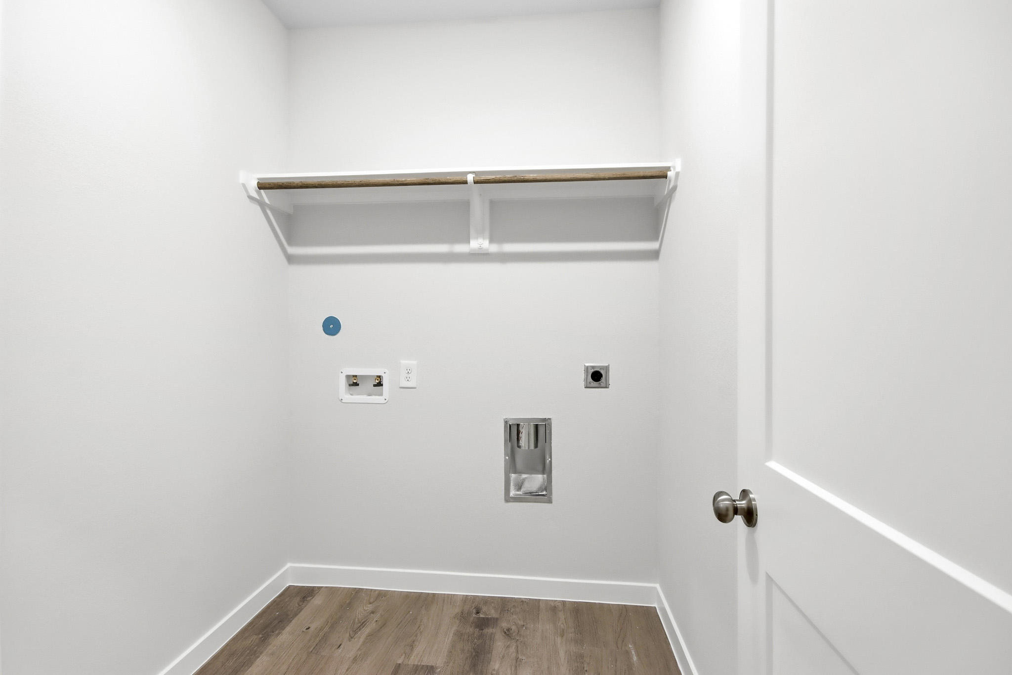 A white wall with a light fixture.
