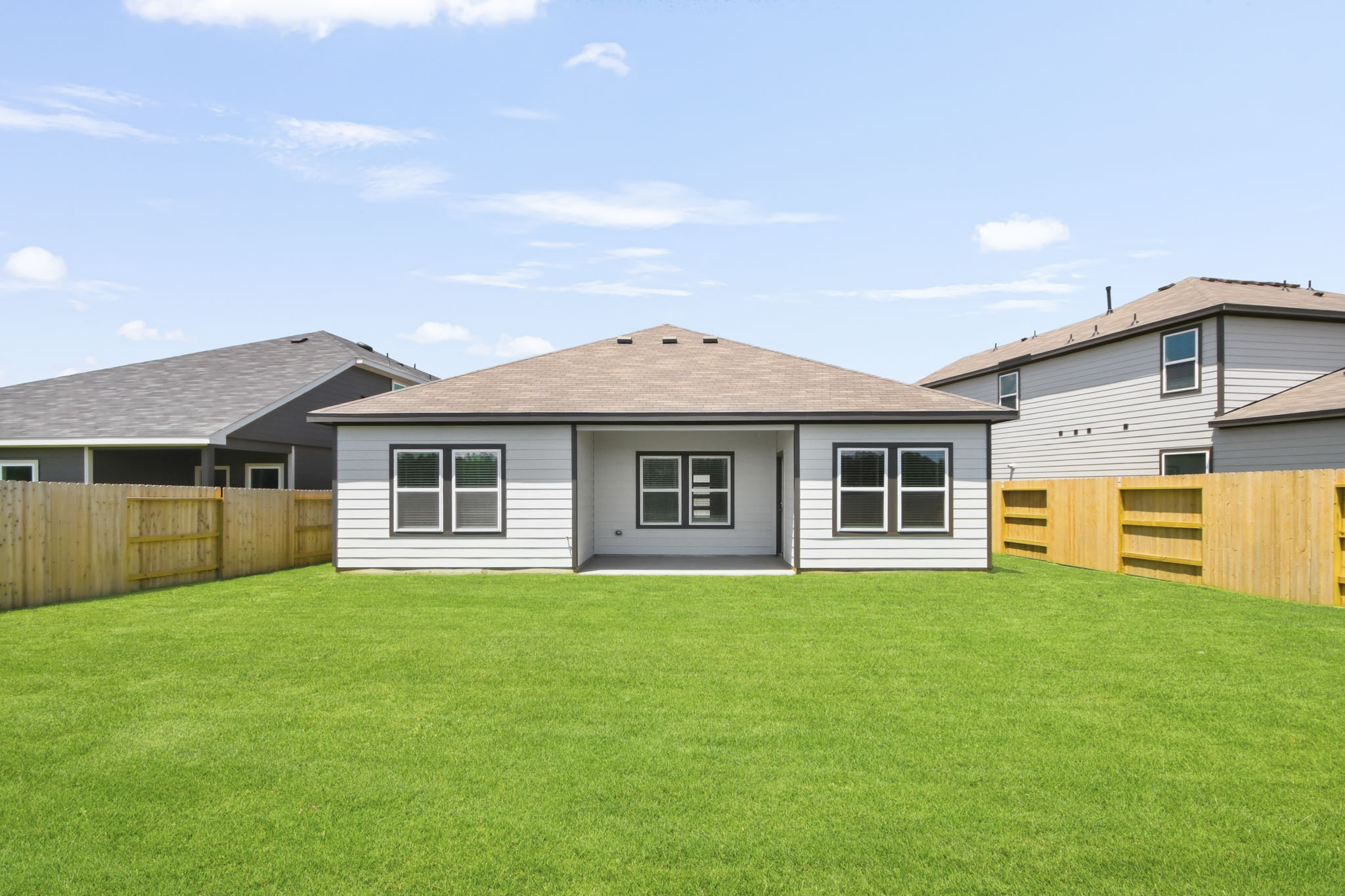 A house with a fence and grass.