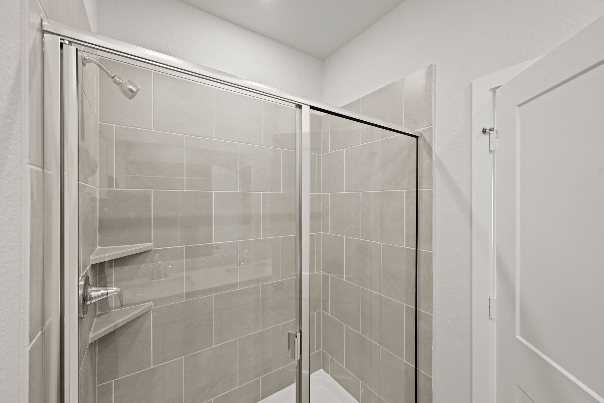 A shower with a glass door.