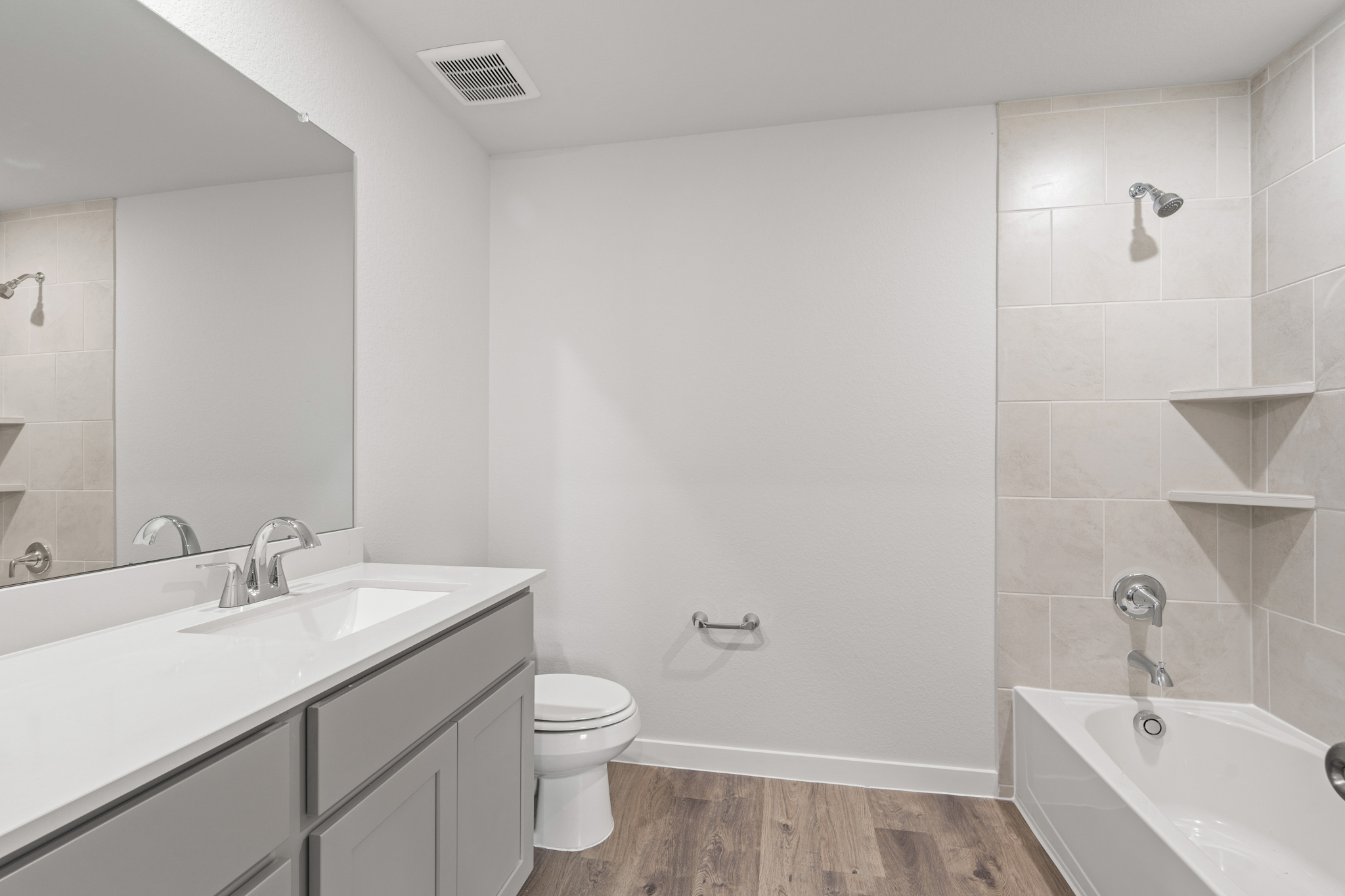 A bathroom with a tub sink and toilet.