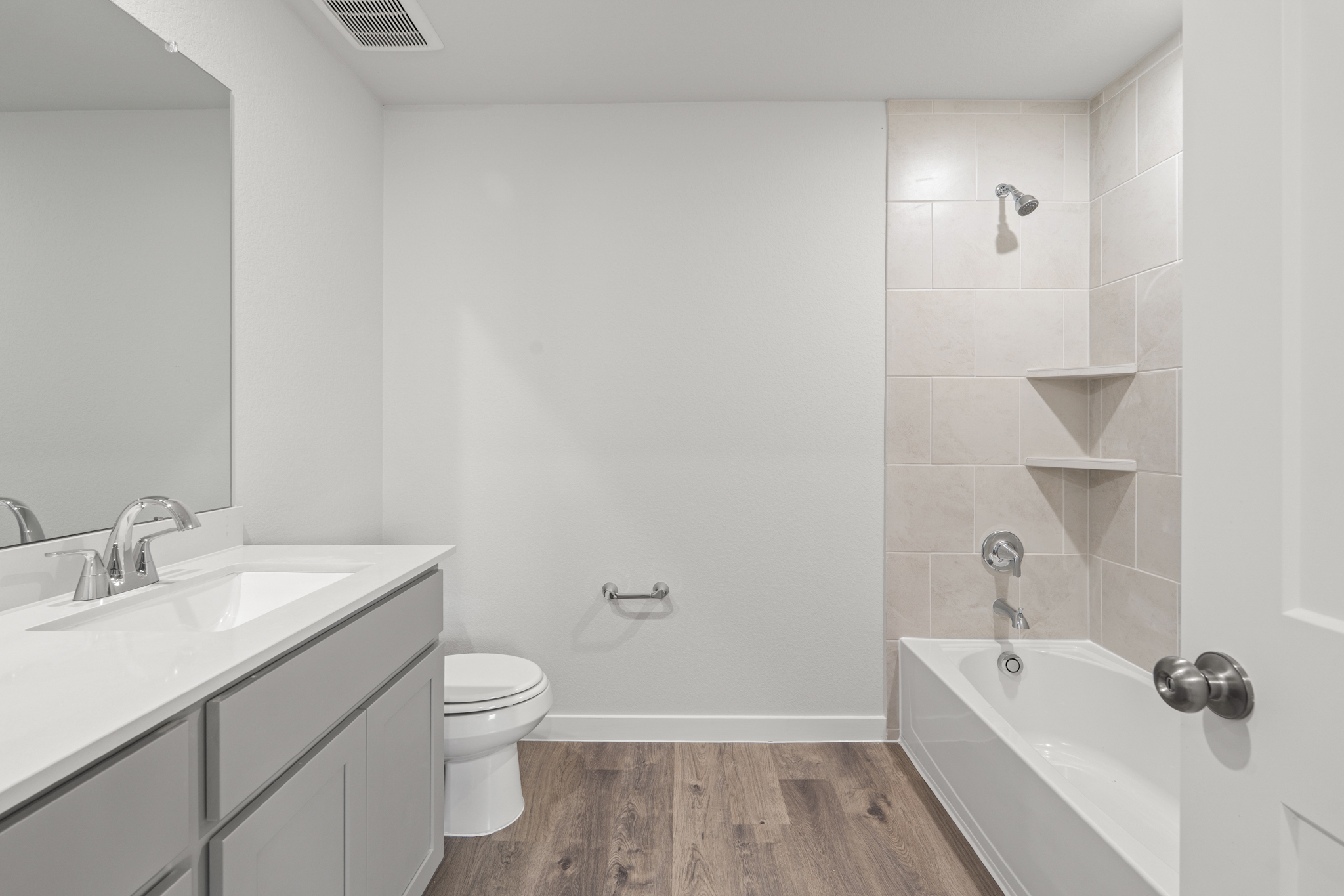 A bathroom with a tub toilet and sink.