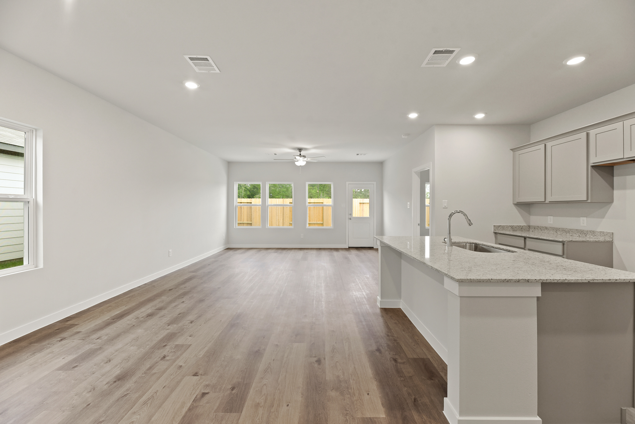 A kitchen with a wood floor.