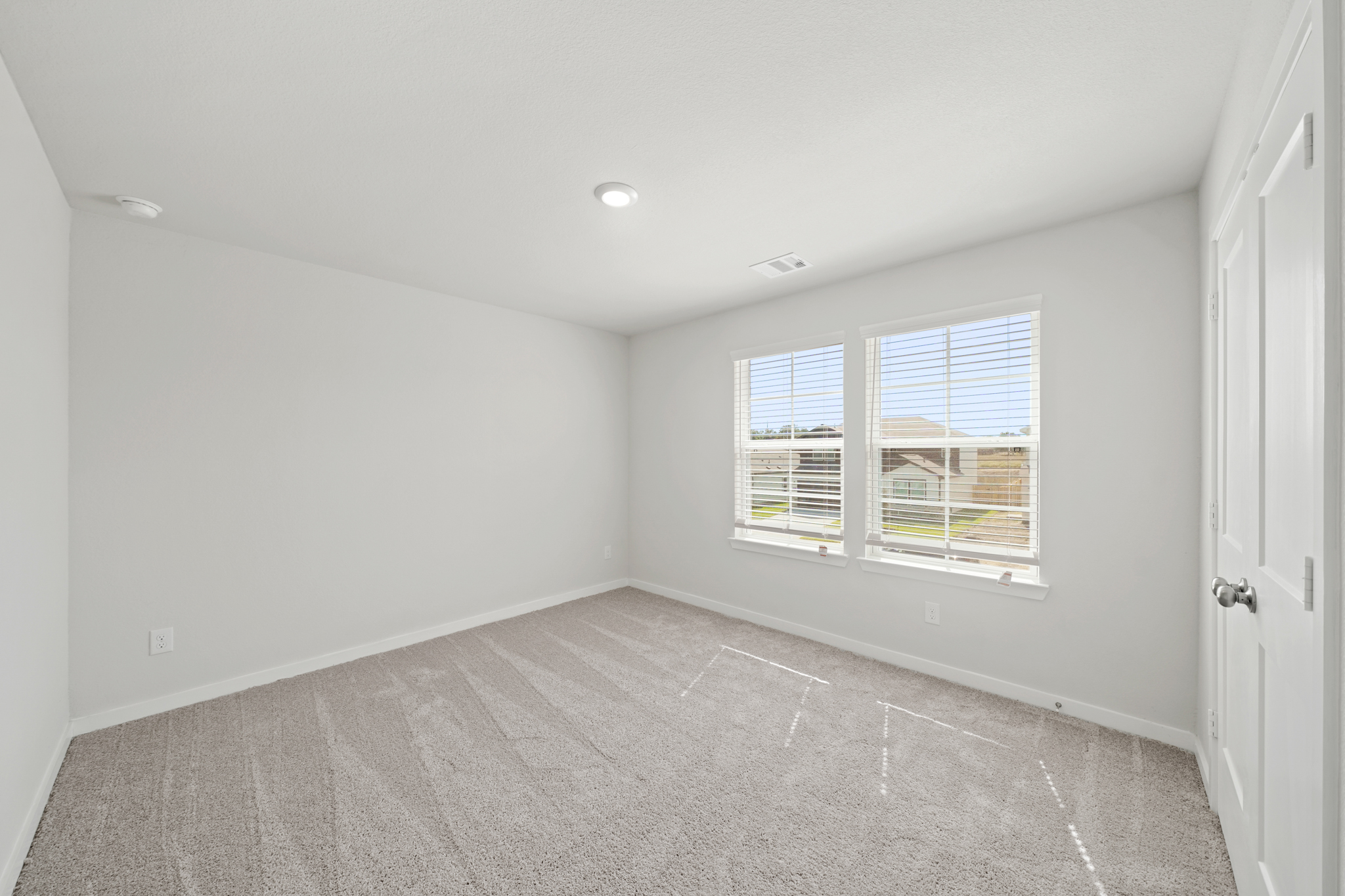 A room with a window and a door.