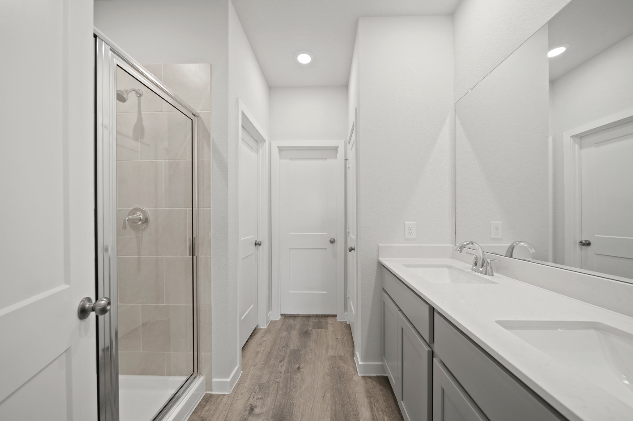 A bathroom with white cabinets.